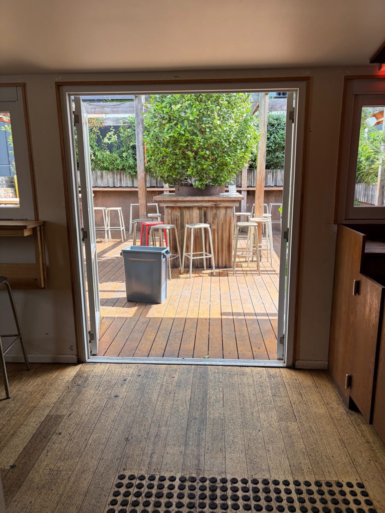 Rear double doors opening to the outdoor terrace and tree. Opening width: 1,430 mm.